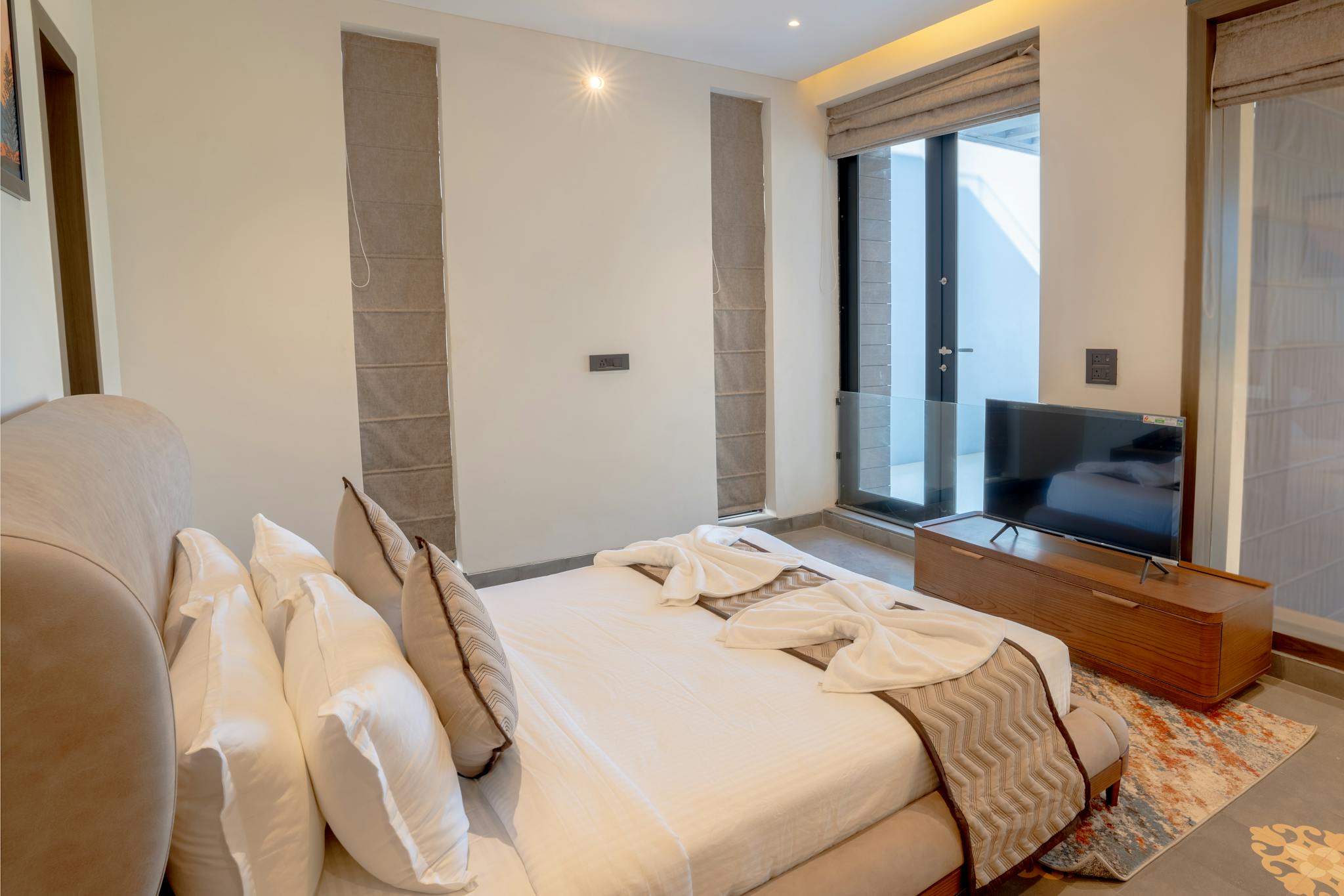 Elegant modern bedroom in a luxurious villa located in Saligao, Goa, India.