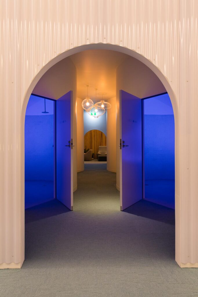 Float tank room with blue ambient lighting at Beyond Rest Melbourne