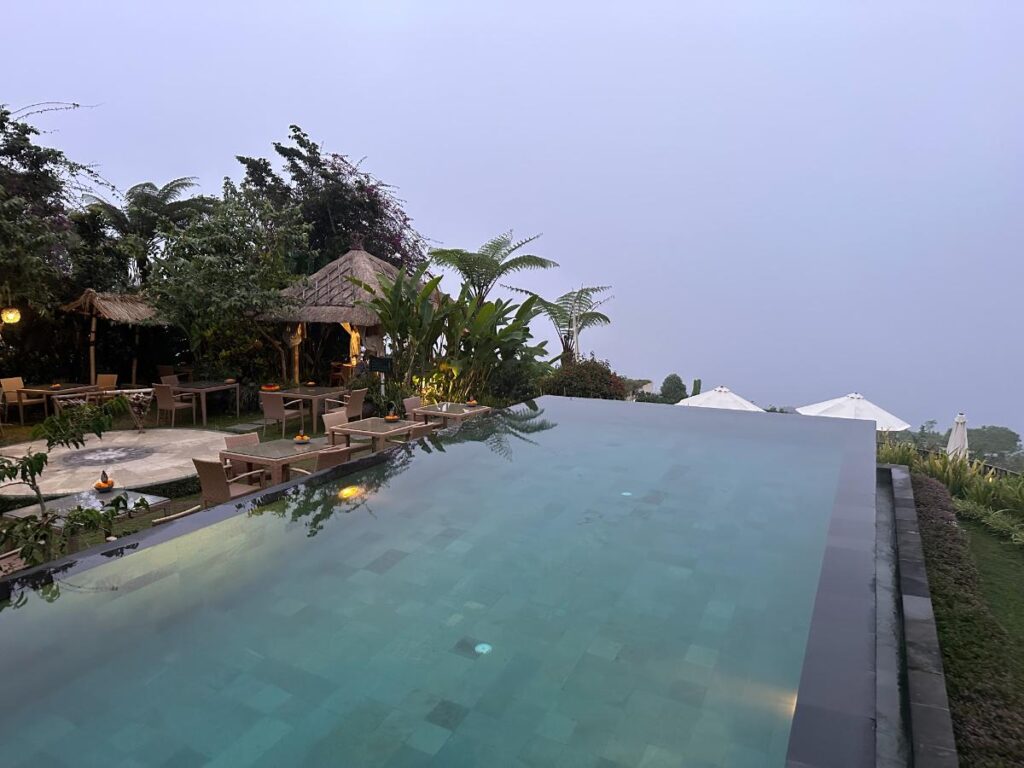 Überblick über den Poolbereich der Munduk Moding Plantation Bali mit langem Infinity-Pool, der sich zum Hochlandhorizont erstreckt