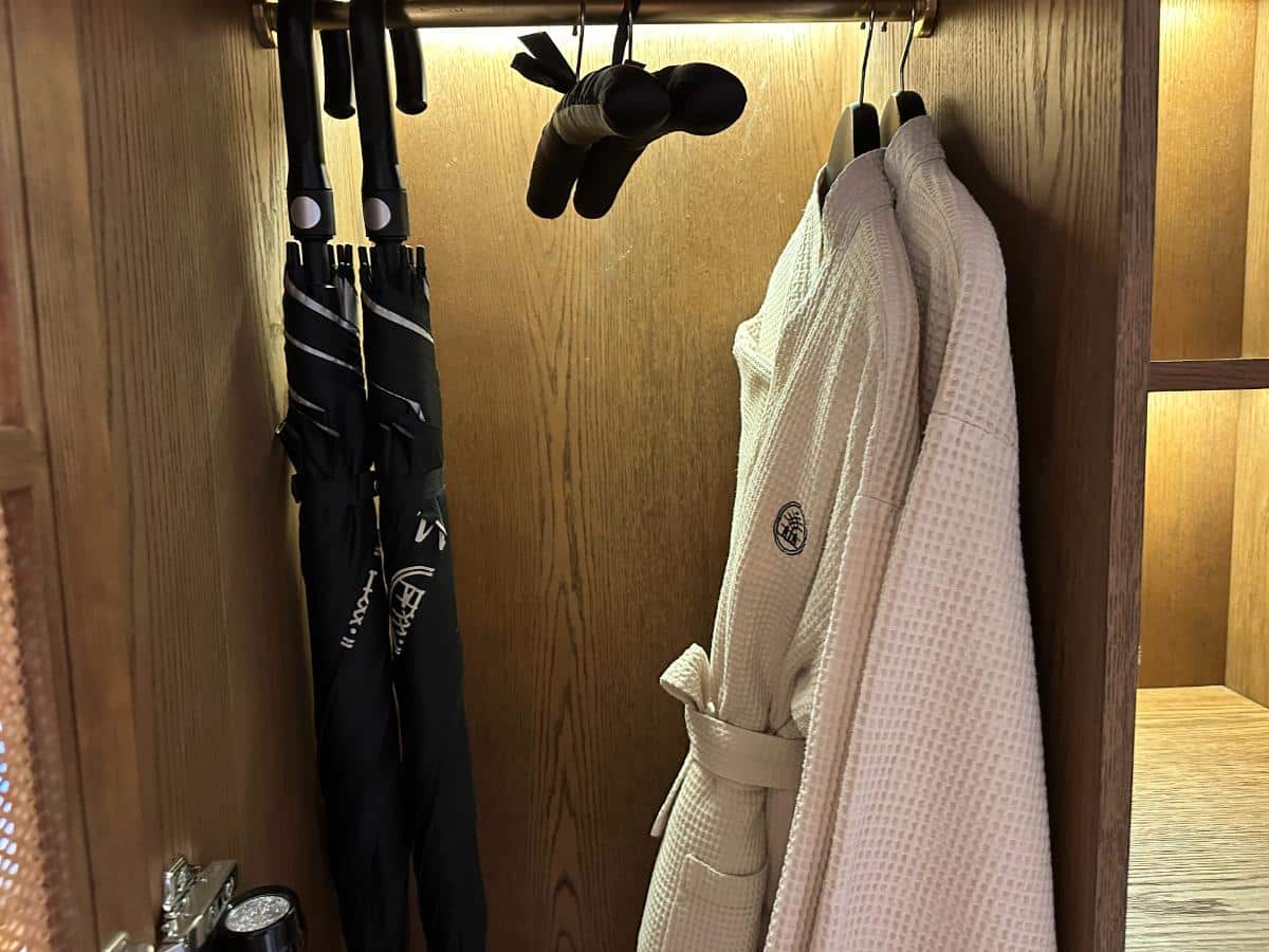 Bathrobes and umbrellas hanging in the villa wardrobe, Namia River Retreat, Hoi An, Vietnam