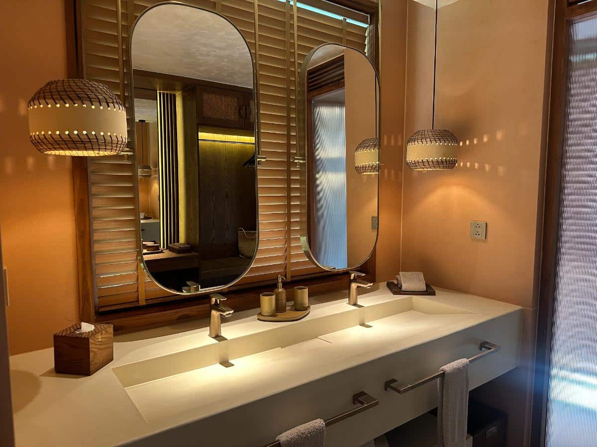Twin vanity with double mirrors and pendant lighting in the villa bathroom, Namia River Retreat, Hoi An, Vietnam
