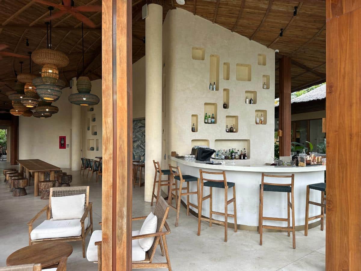 Lobby bar and lounge with cane pendant lights and stools, Namia River Retreat, Hoi An, Vietnam