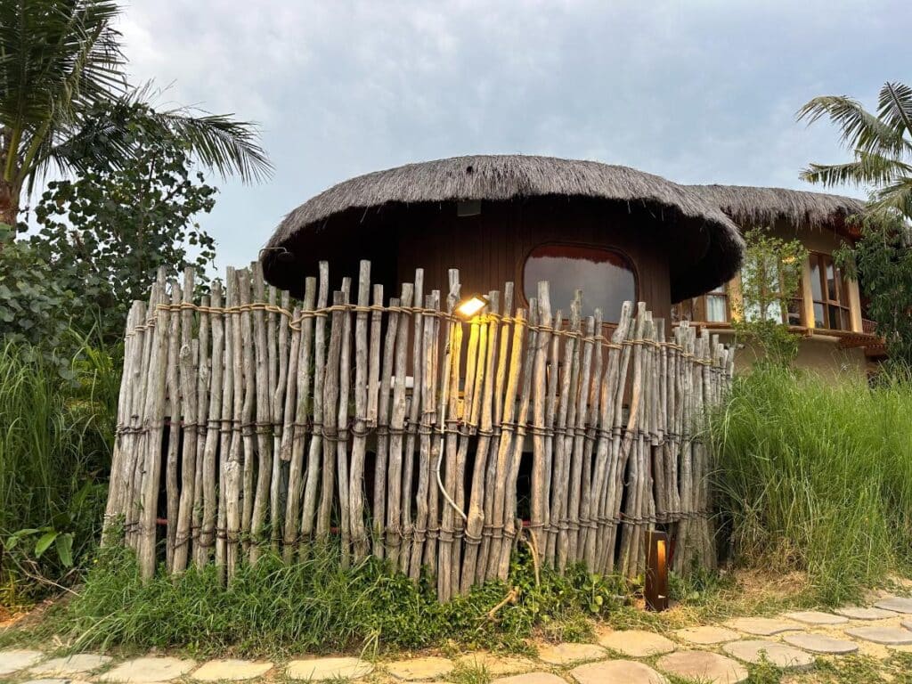 Thatched-roof private spa hut enclosed by bamboo fence, Namia River Retreat, Hoi An, Vietnam