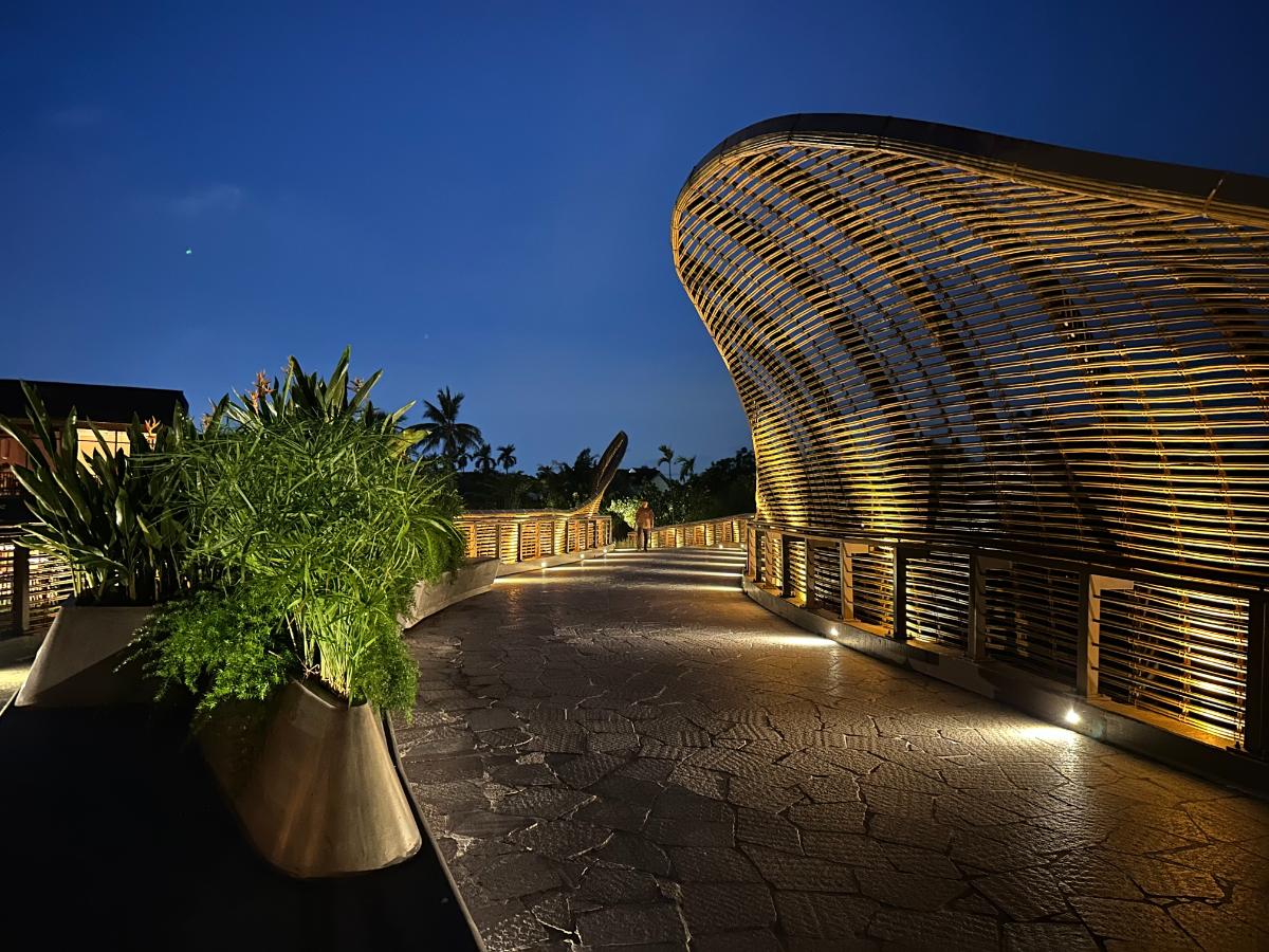 Curved bamboo pavilion architecture lit at twilight, Namia River Retreat, Hoi An, Vietnam