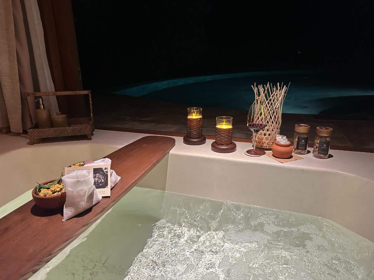 Outdoor bath ritual with candles and incense beside the private pool, Namia River Retreat, Hoi An, Vietnam
