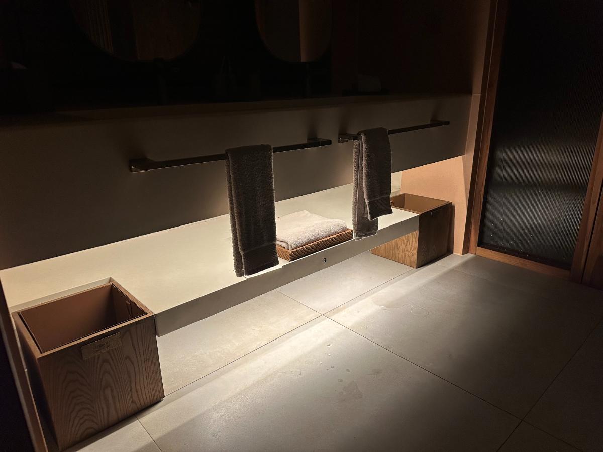Walk-in wardrobe with hangers and folded shelving inside the pool villa, Namia River Retreat, Hoi An, Vietnam