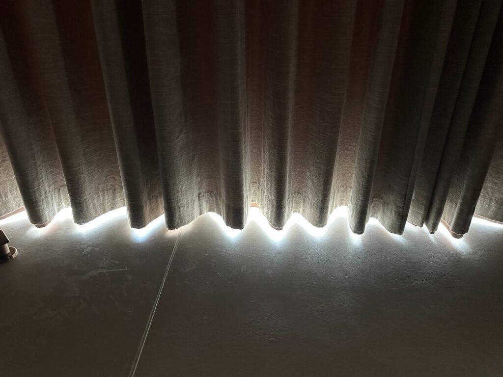 Close-up of pleated blackout curtains with light edge in the pool villa, Namia River Retreat, Hoi An, Vietnam