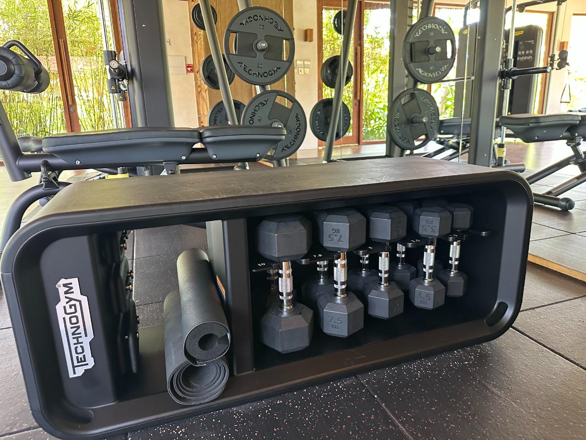 Technogym dumbbell rack with free weights in the fitness center, Namia River Retreat, Hoi An, Vietnam