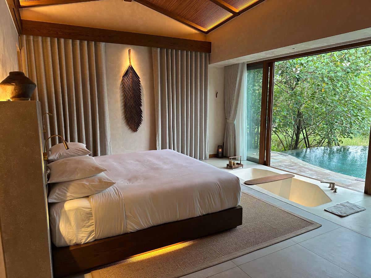 Private pool villa king bedroom with vaulted bamboo ceiling and pool view, Namia River Retreat, Hoi An, Vietnam