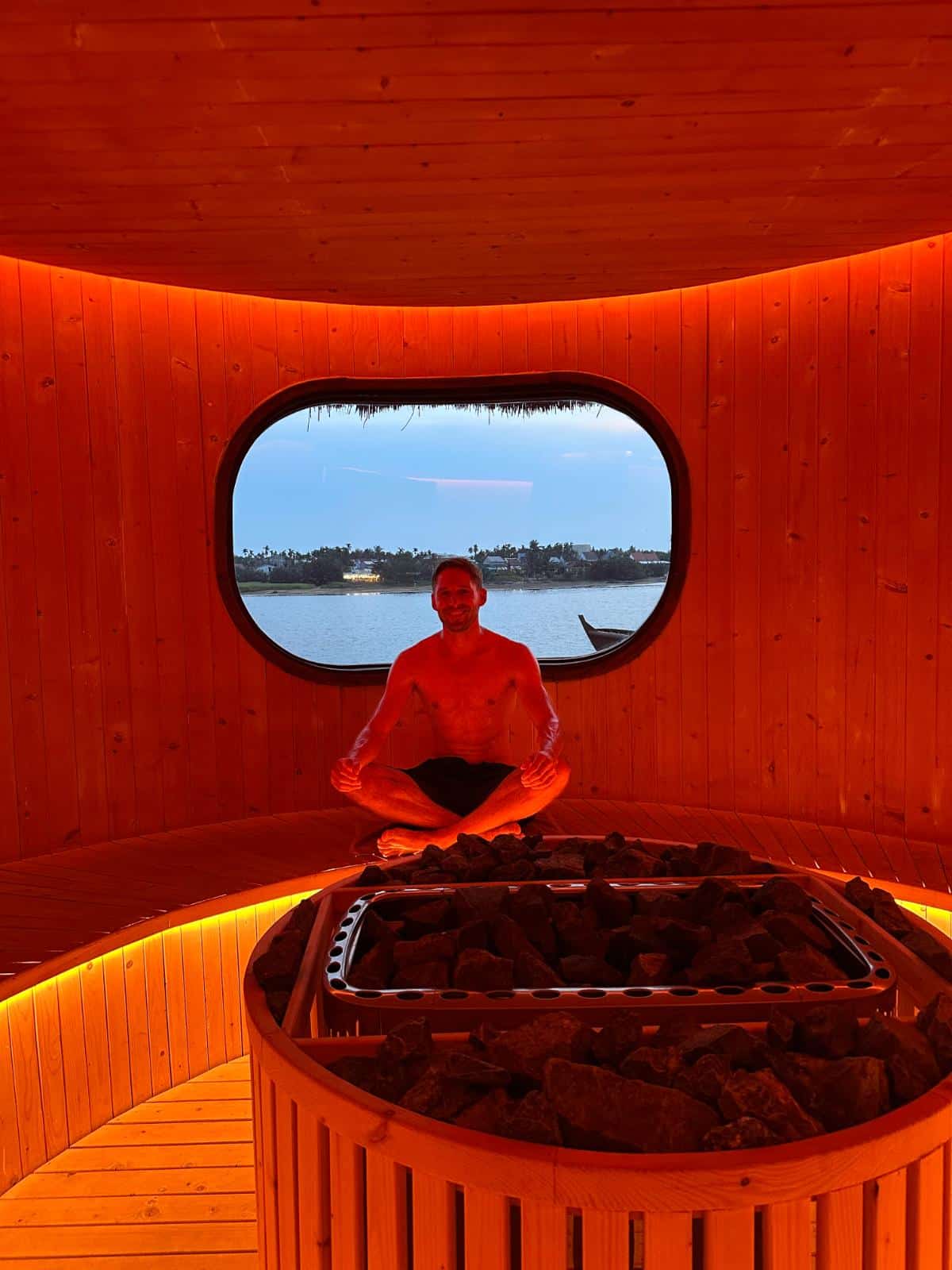 Meditating inside infrared sauna with oval window onto the Thu Bon River, Namia River Retreat, Hoi An, Vietnam