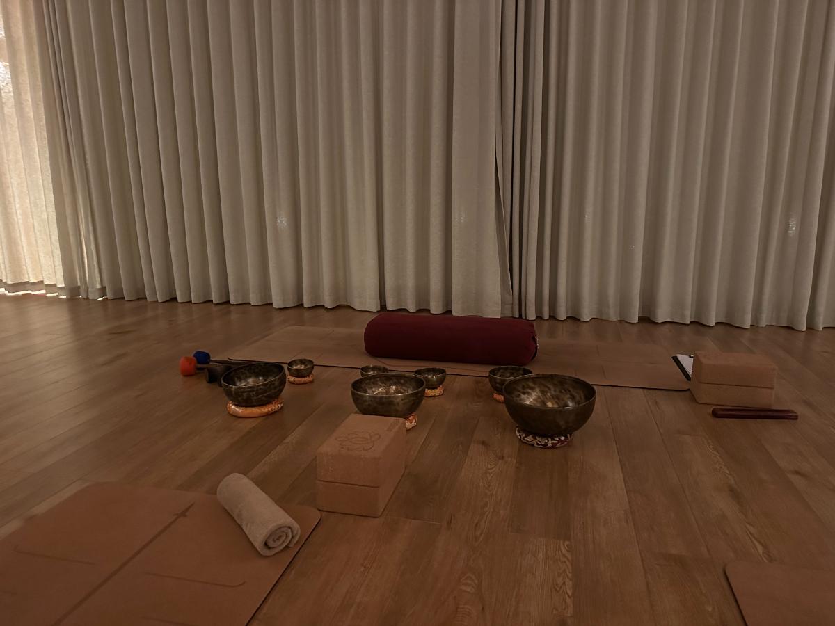 Singing bowls and bolsters laid out on the yoga studio floor, Namia River Retreat, Hoi An, Vietnam