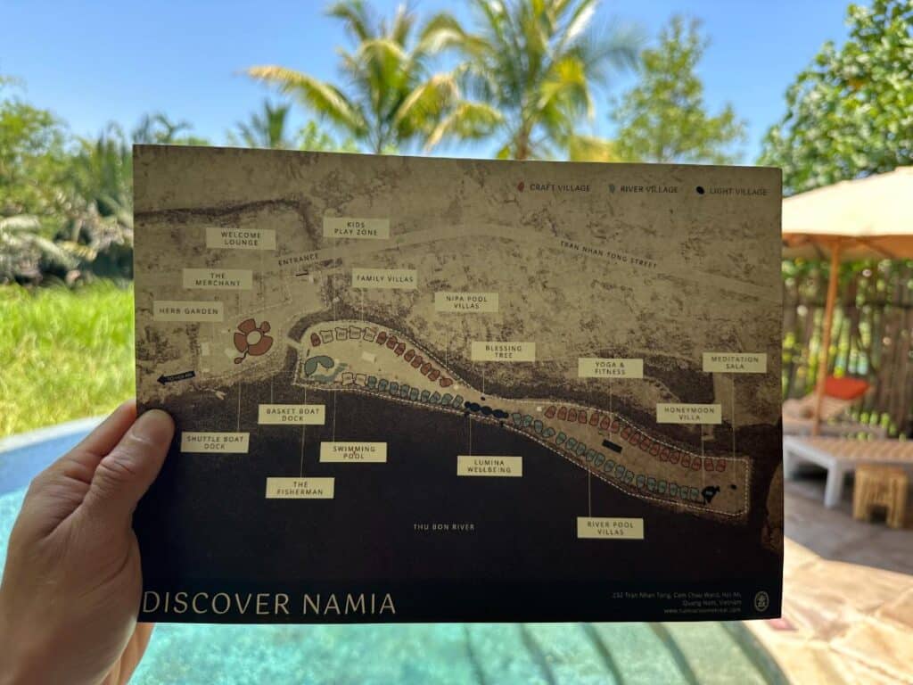 Aerial view of the property with palm canopy and villa rooftops, Namia River Retreat, Hoi An, Vietnam